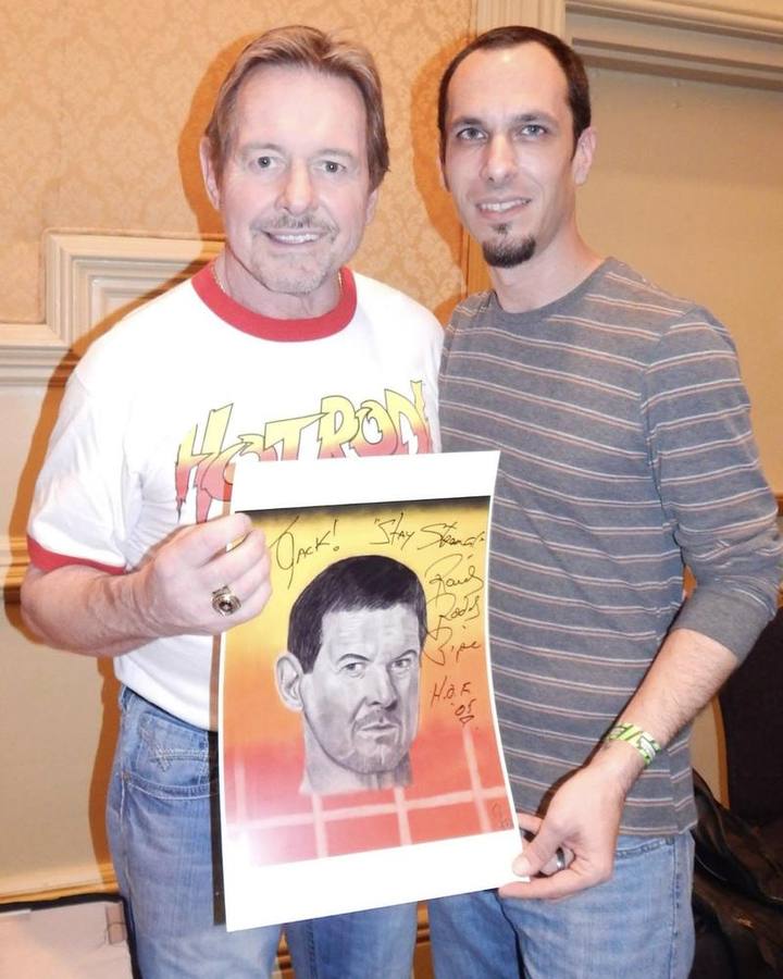 Signed print of a wrestling legend drawing, held at a signing